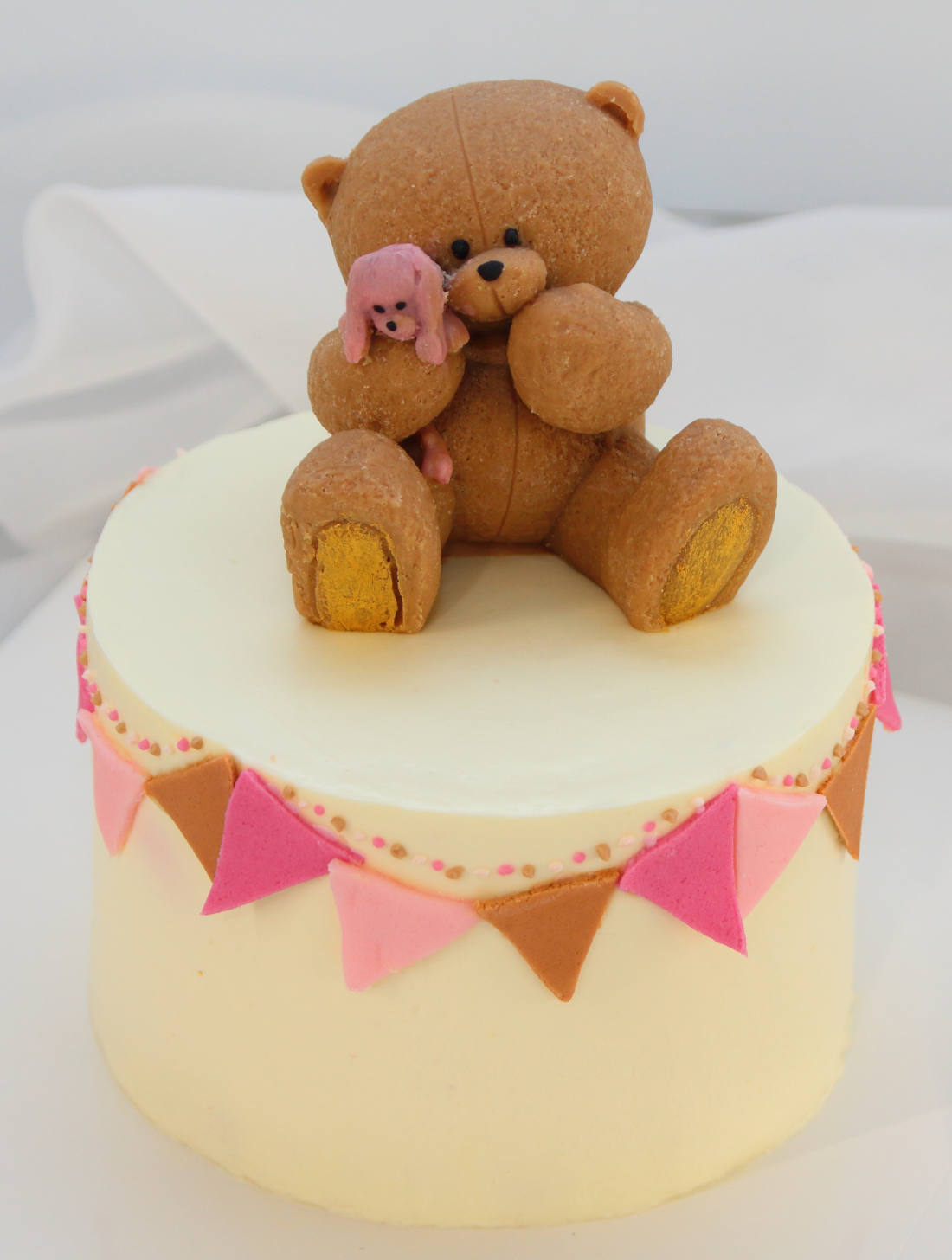 Bear with a rabbit on a cake