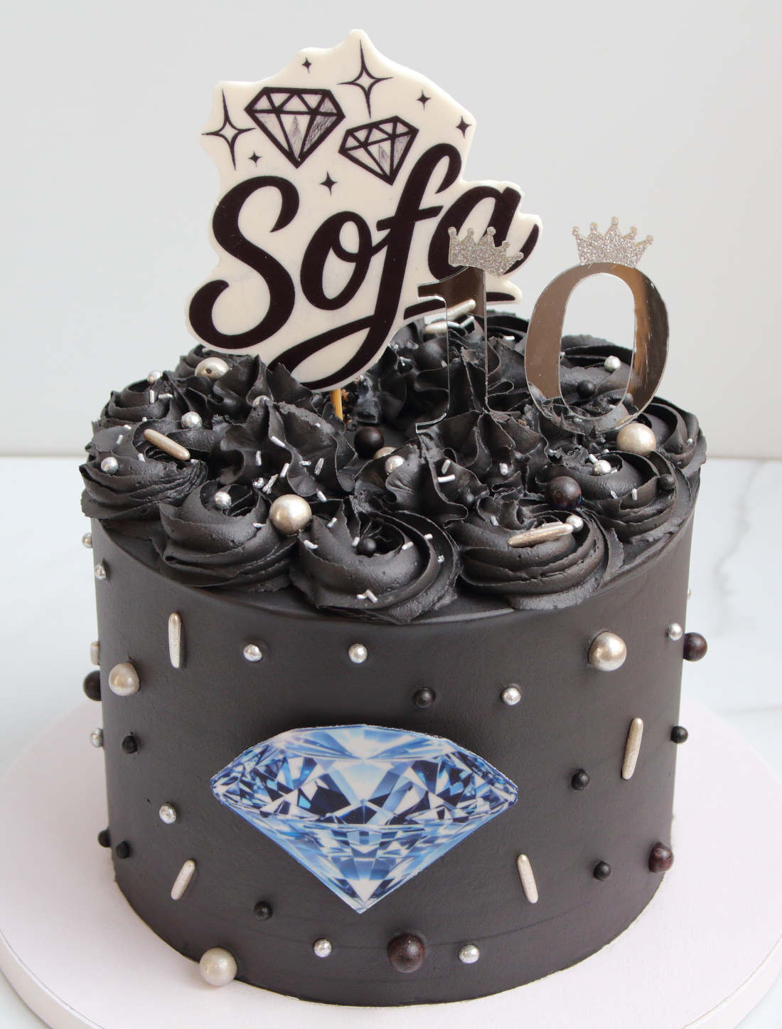 Black cake with diamonds for a girl's birthday