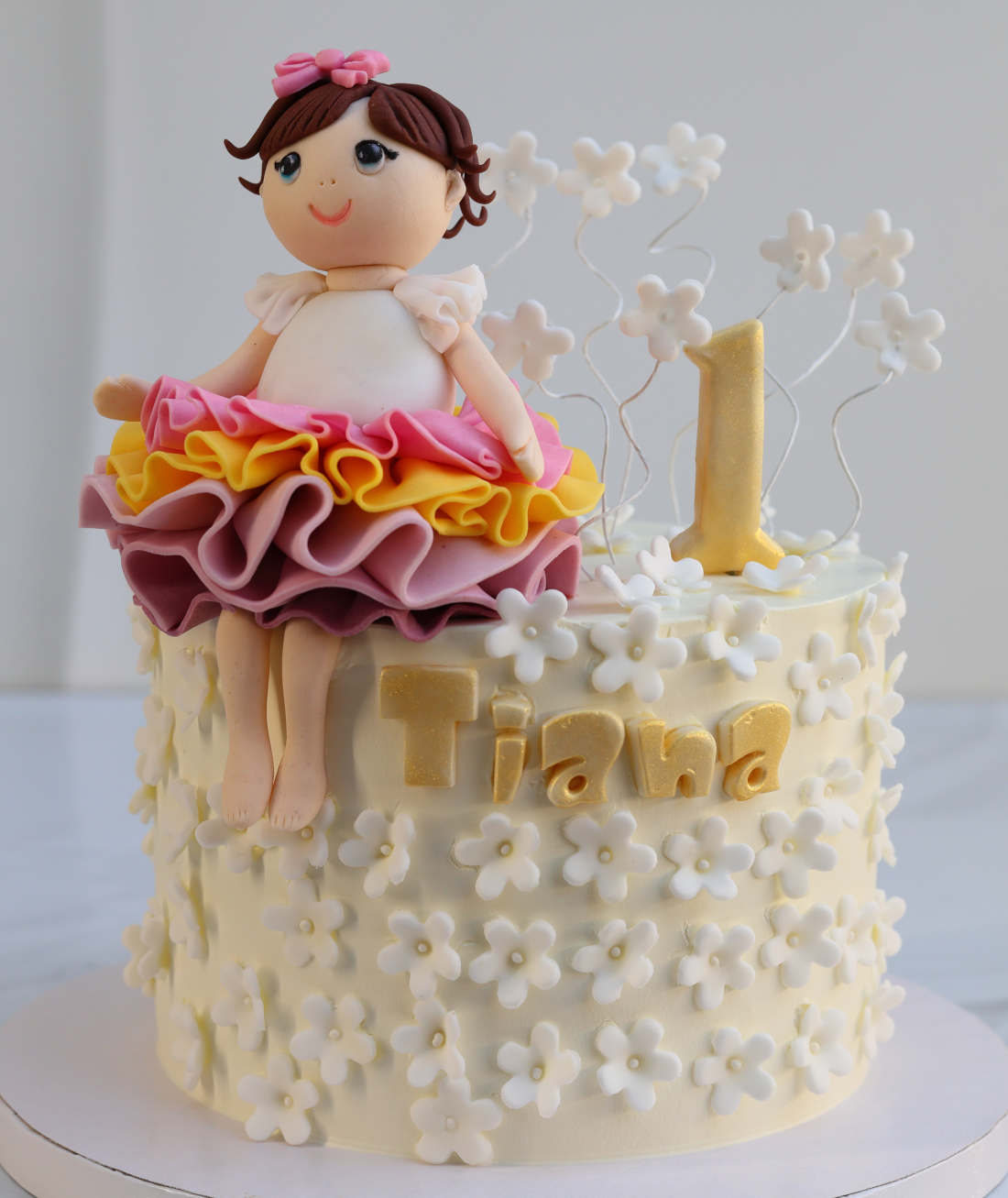 Cake with a figurine of a girl for 1 year