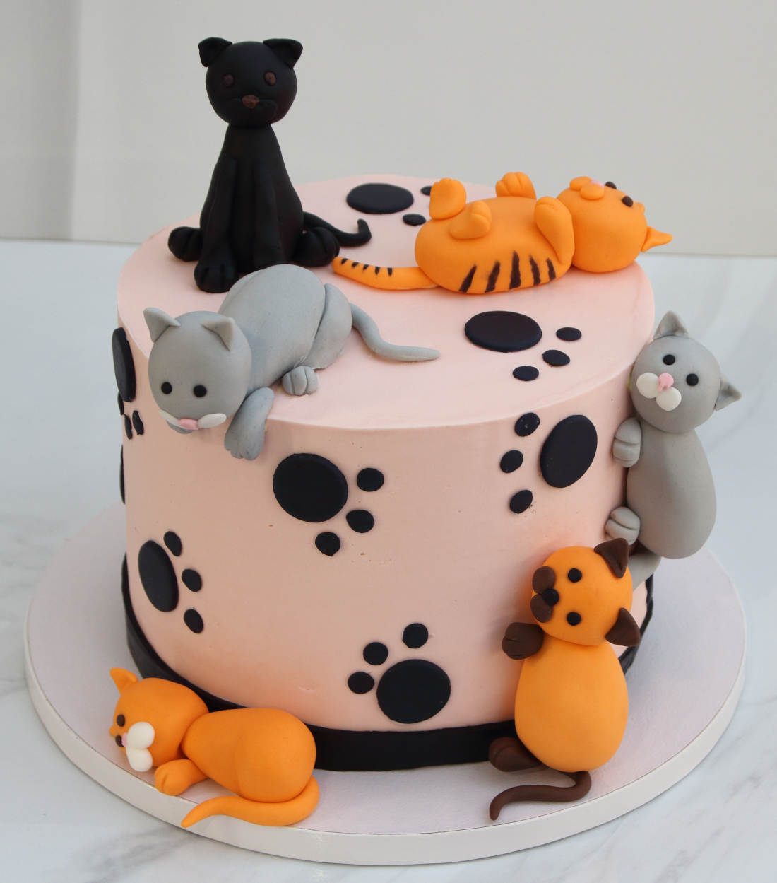 Cake with playing, sitting and lying cats
