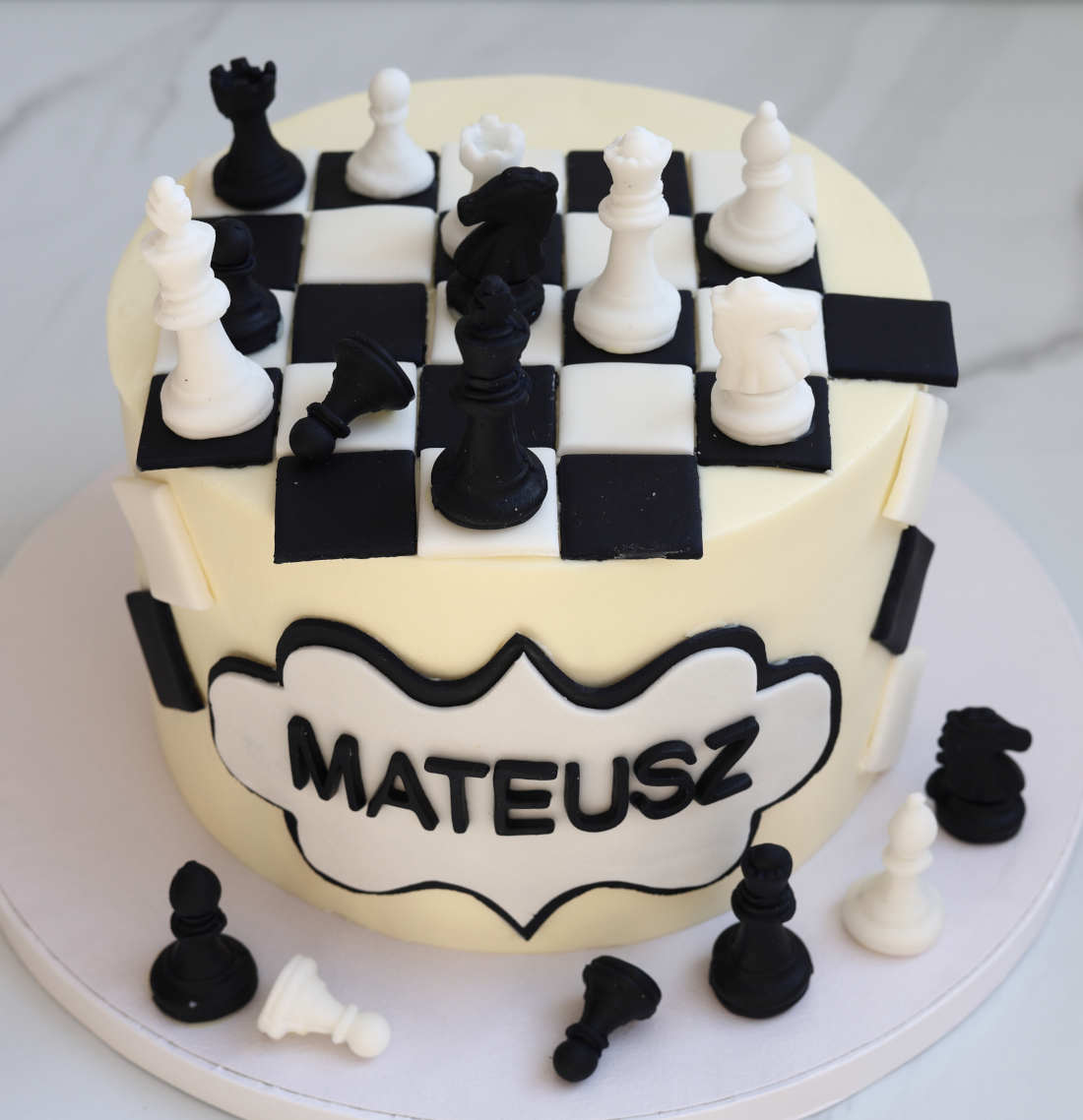 Chess cake with a board, pieces, and the birthday person's name