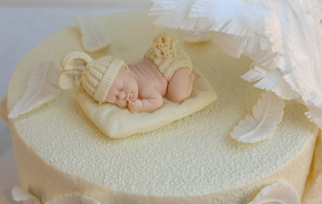 Sleeping chocolate baby on a cake for a little child