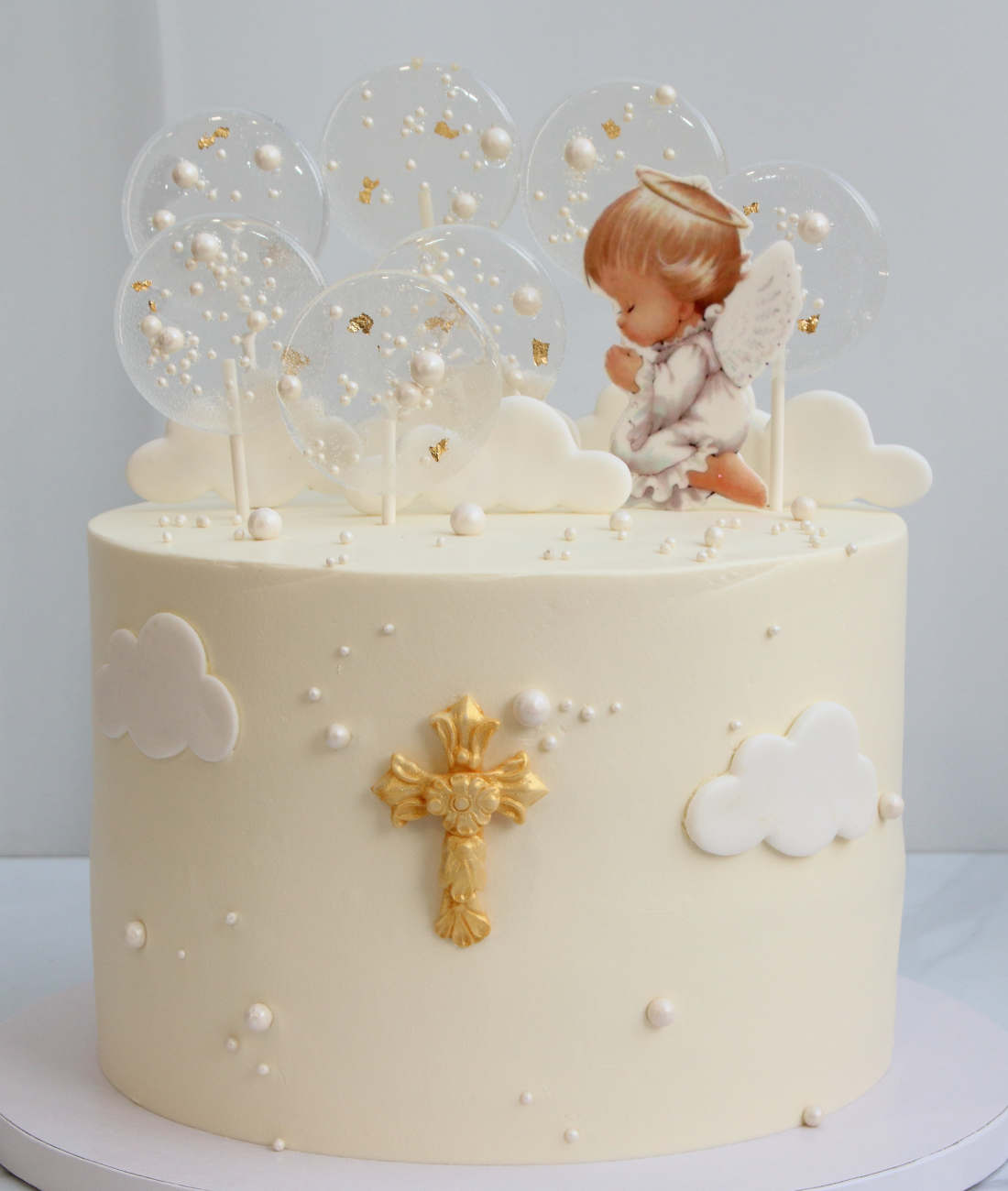 Cake with an angel and a cross for a baby christening