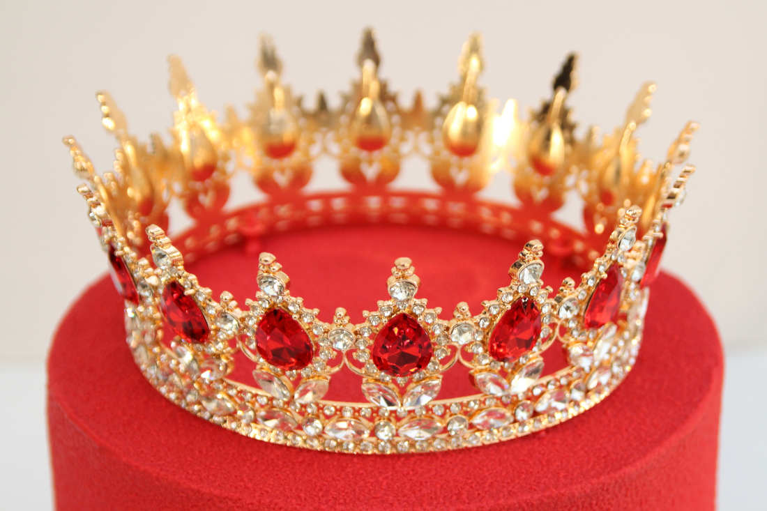 Crown on the cake with red chocolate velour