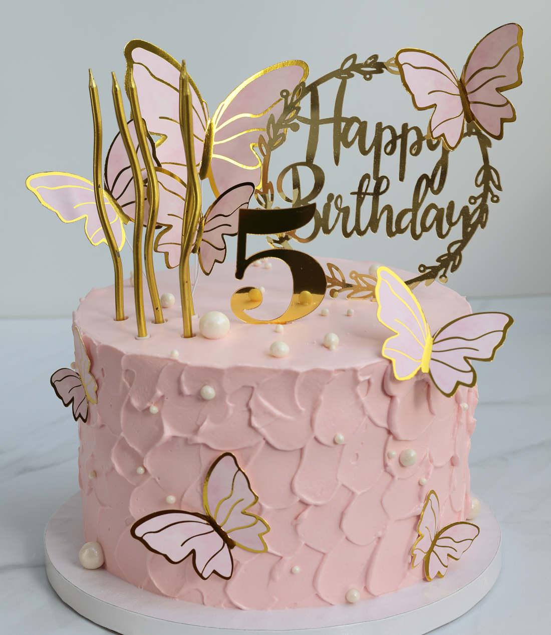 Butterflies with golden wings on a children's cake