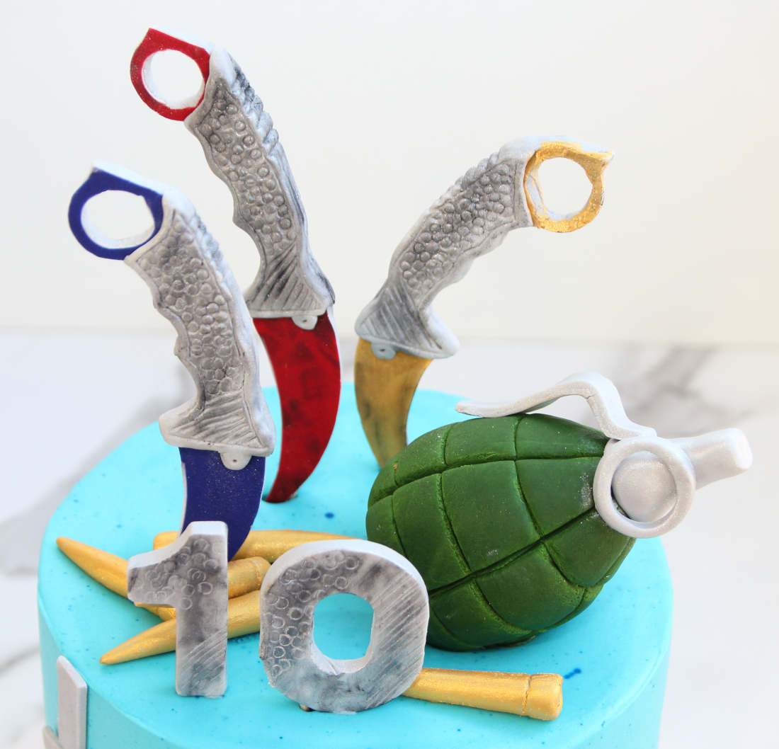 Cartridges, knives and a grenade on a cake