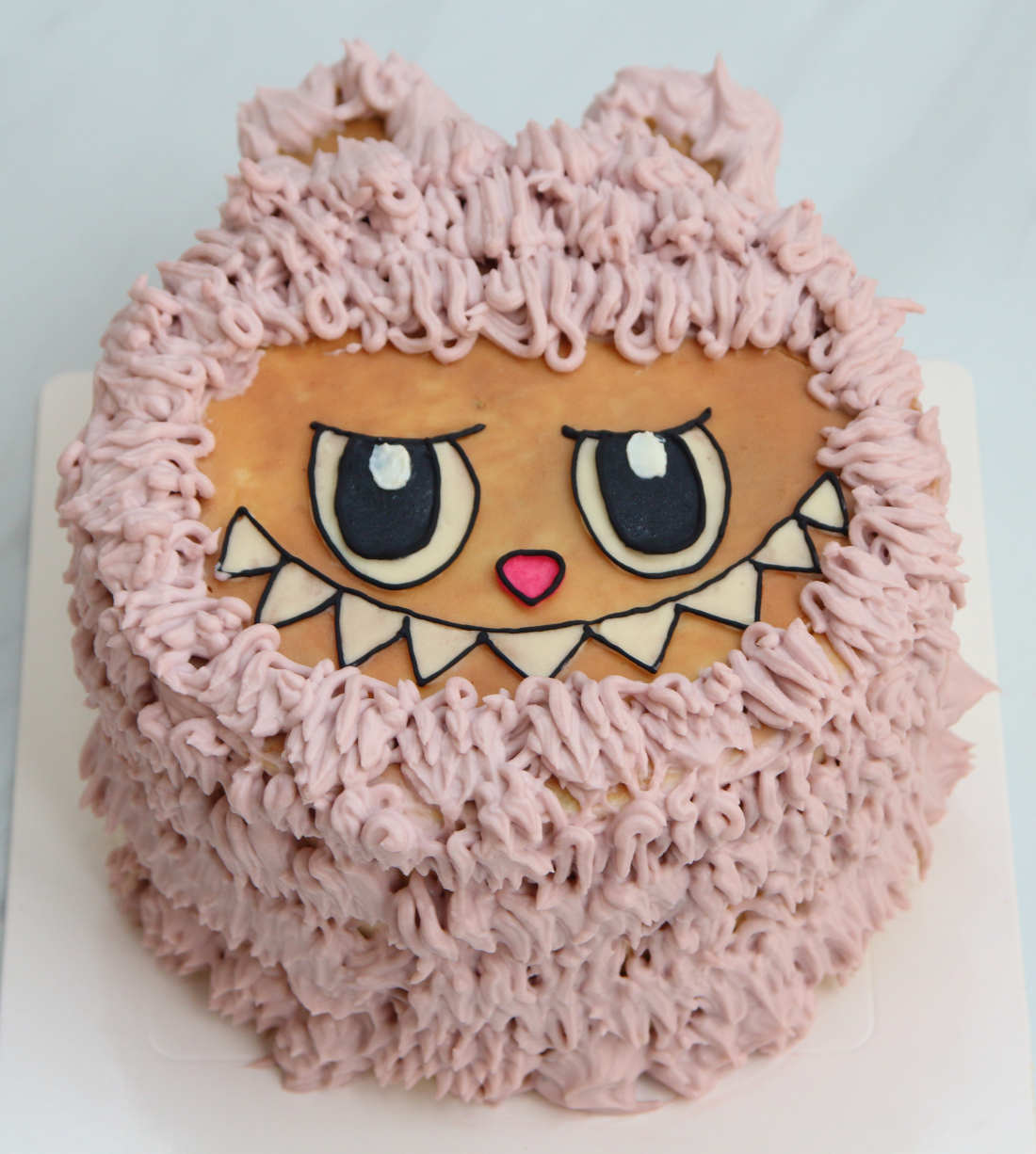 Labubu cake with ears and teeth