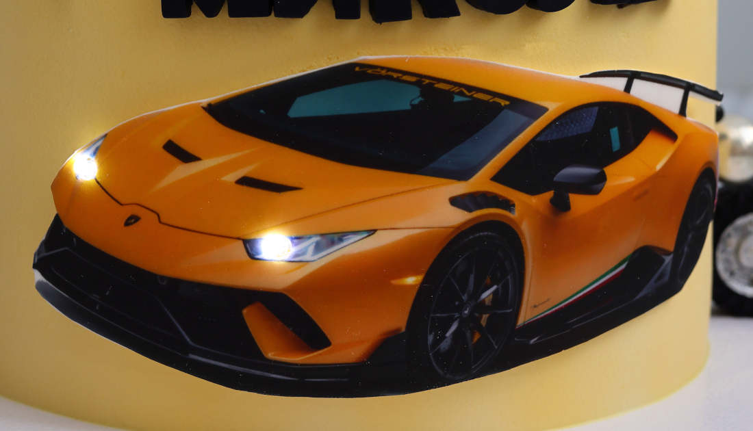 Glowing LED headlights on the Lamborghini cake