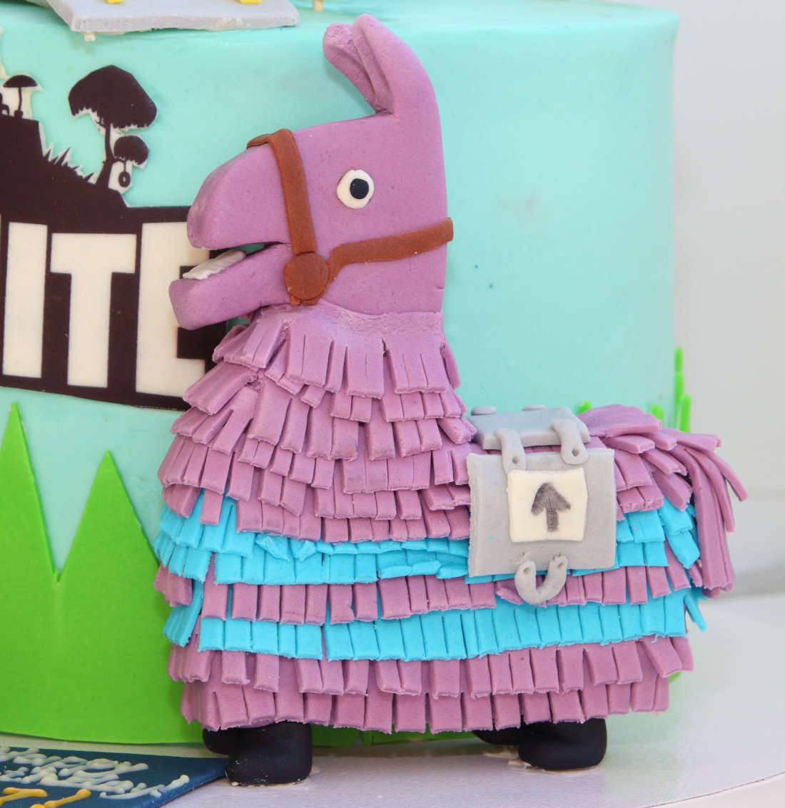 Edible llama piñata on a computer game cake