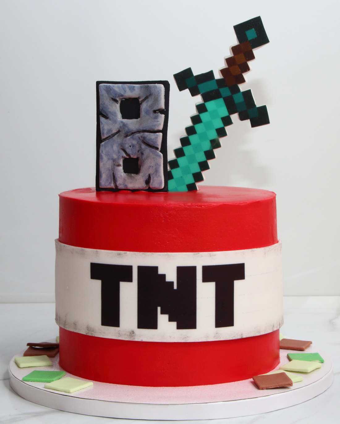 Minecraft cake with TNT, sword, and birthday boy's age