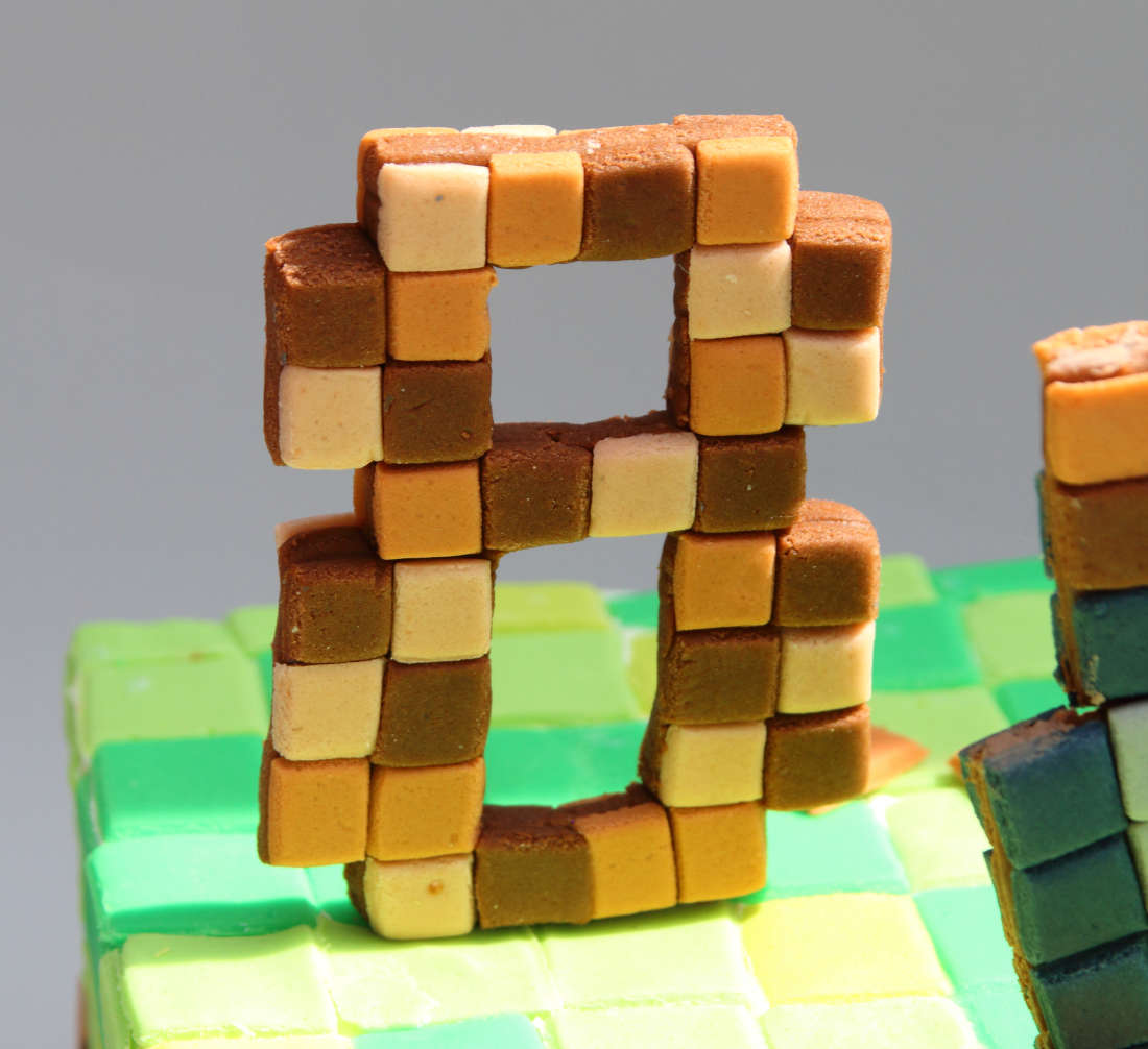 Pickaxe and age 8 on a Minecraft cake