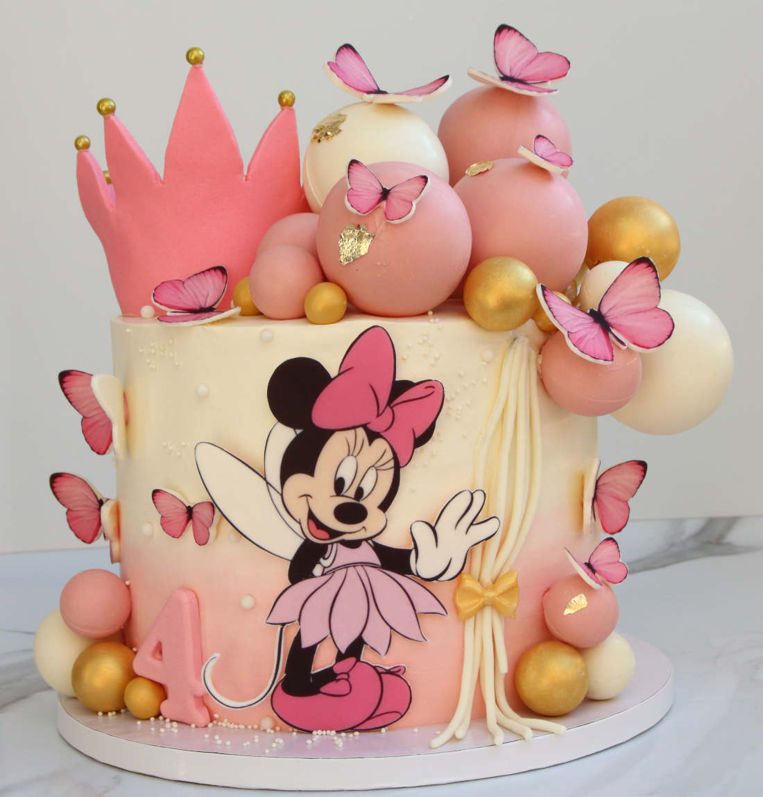 Cake with butterflies and Minnie Mouse for a girl's birthday