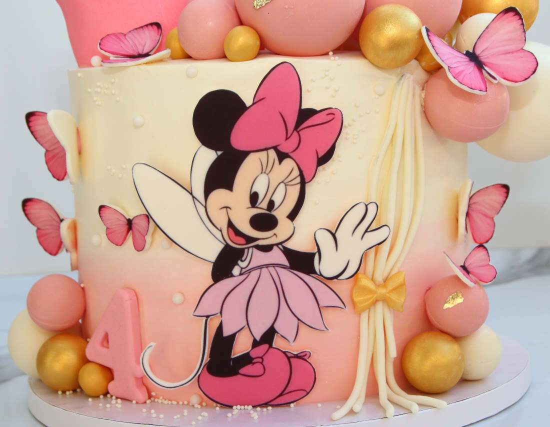 Minnie Mouse and a girl's age on the cake