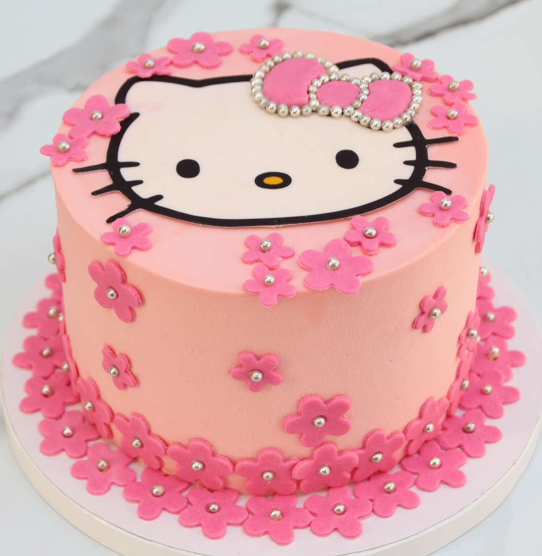 Hello Kitty pink cake with cat, bow and flowers for girl