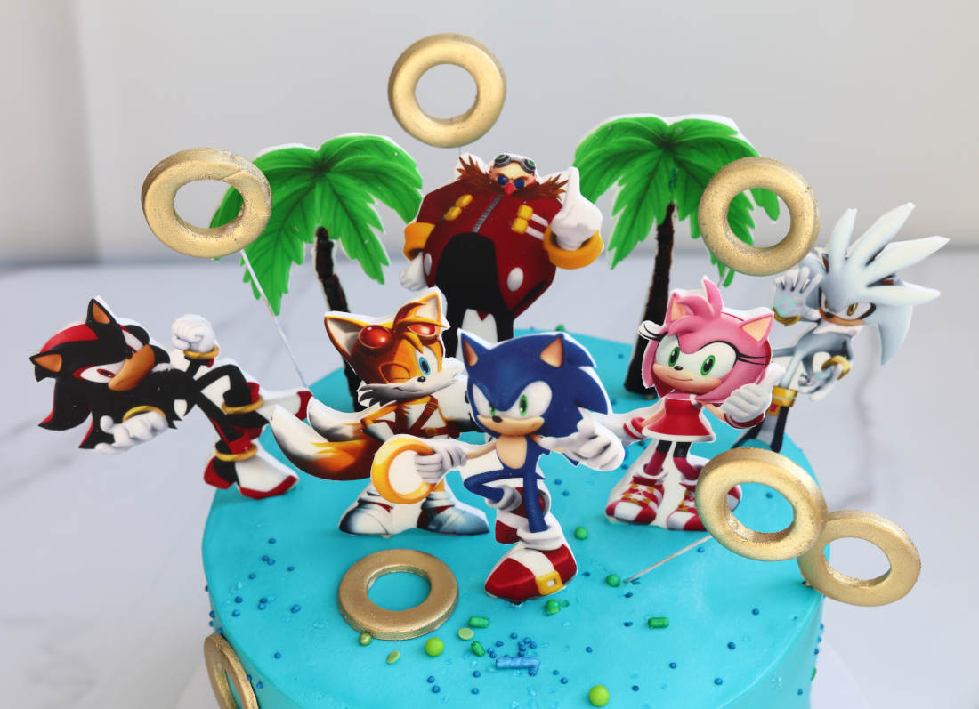 Blue Sonic cake with rings and game characters