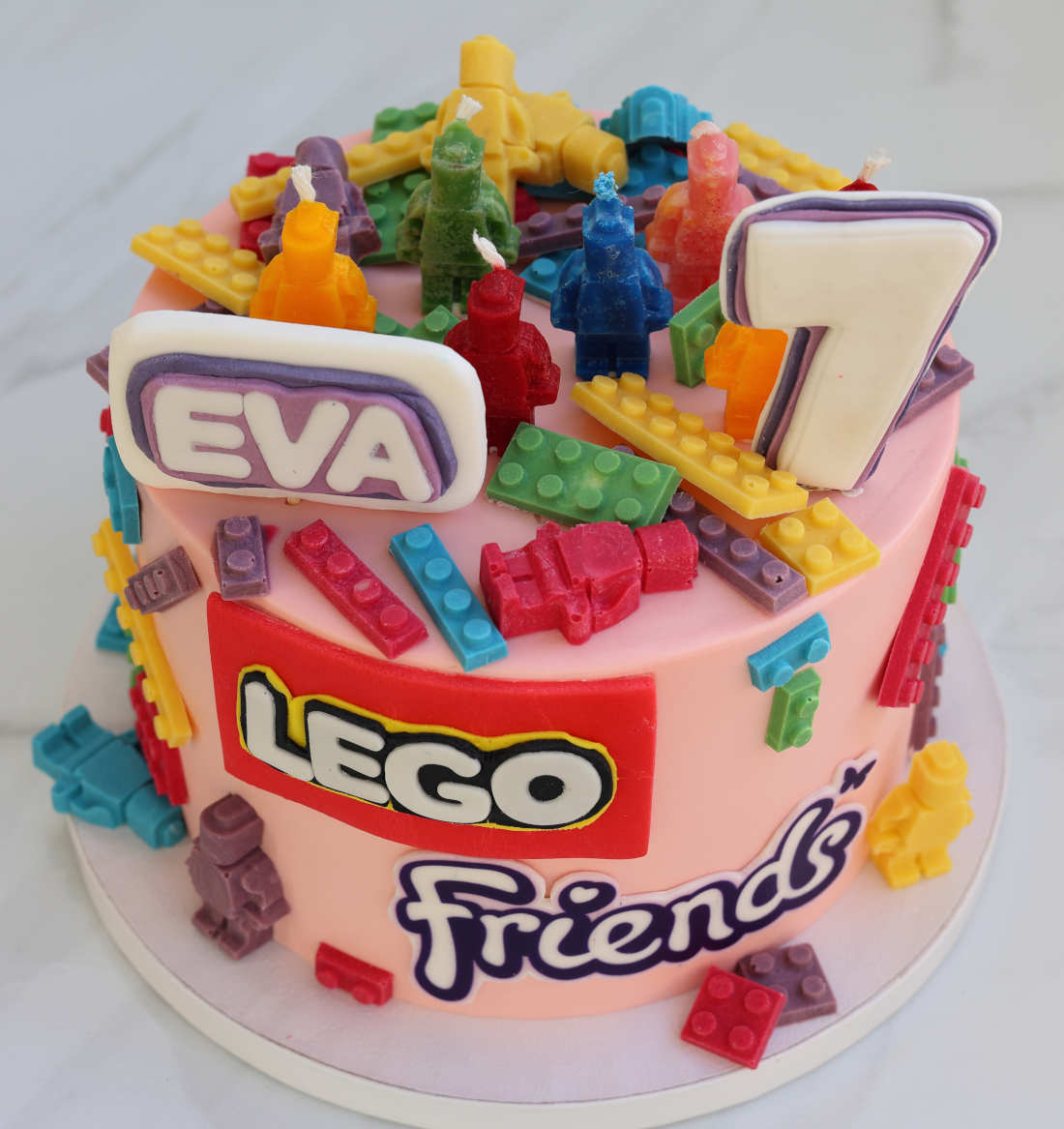 Lego-shaped candles on the cake for the girl