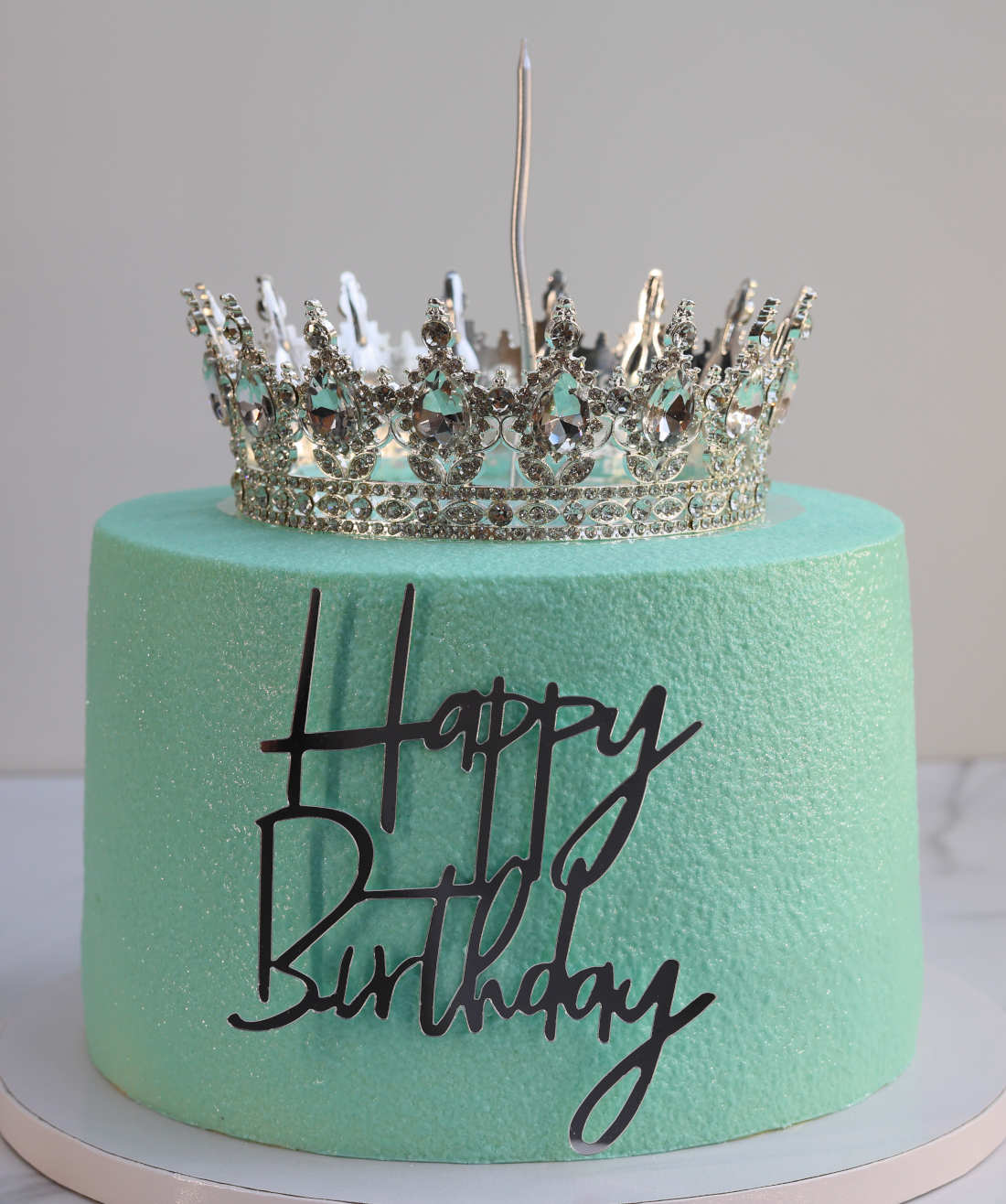 Turquoise cake with a silver crown
