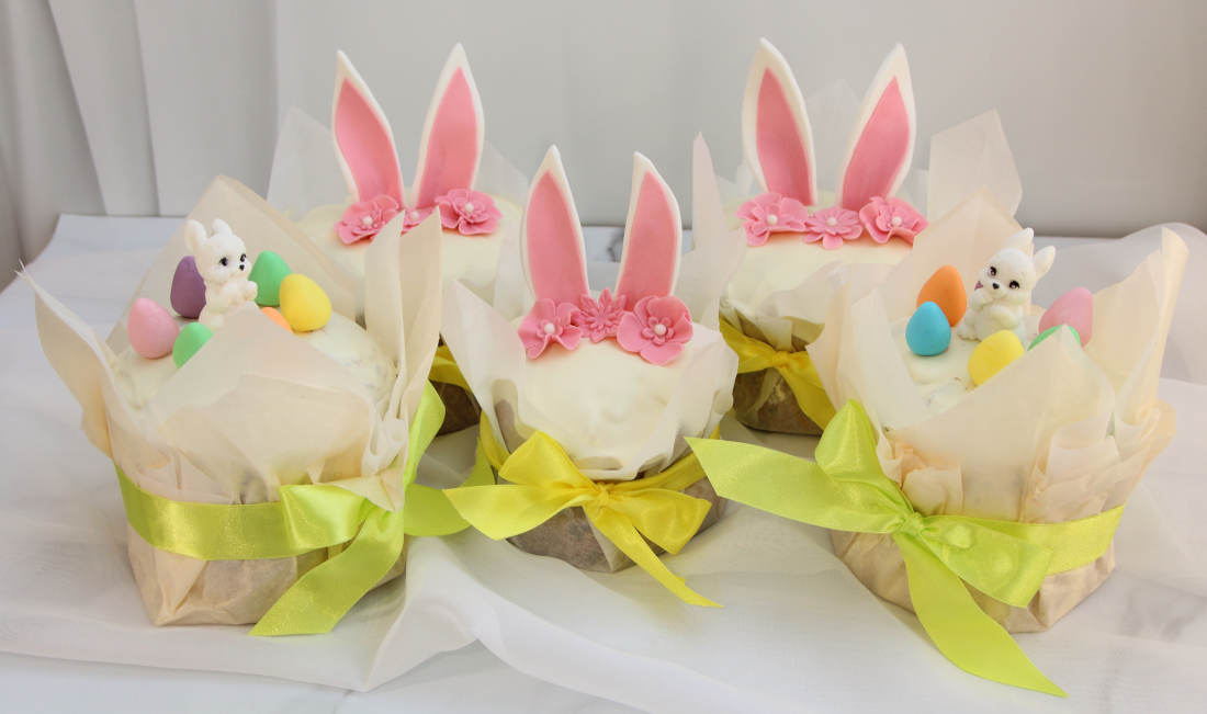 Easter cakes with decorations: ears, flowers, rabbits and painted eggs