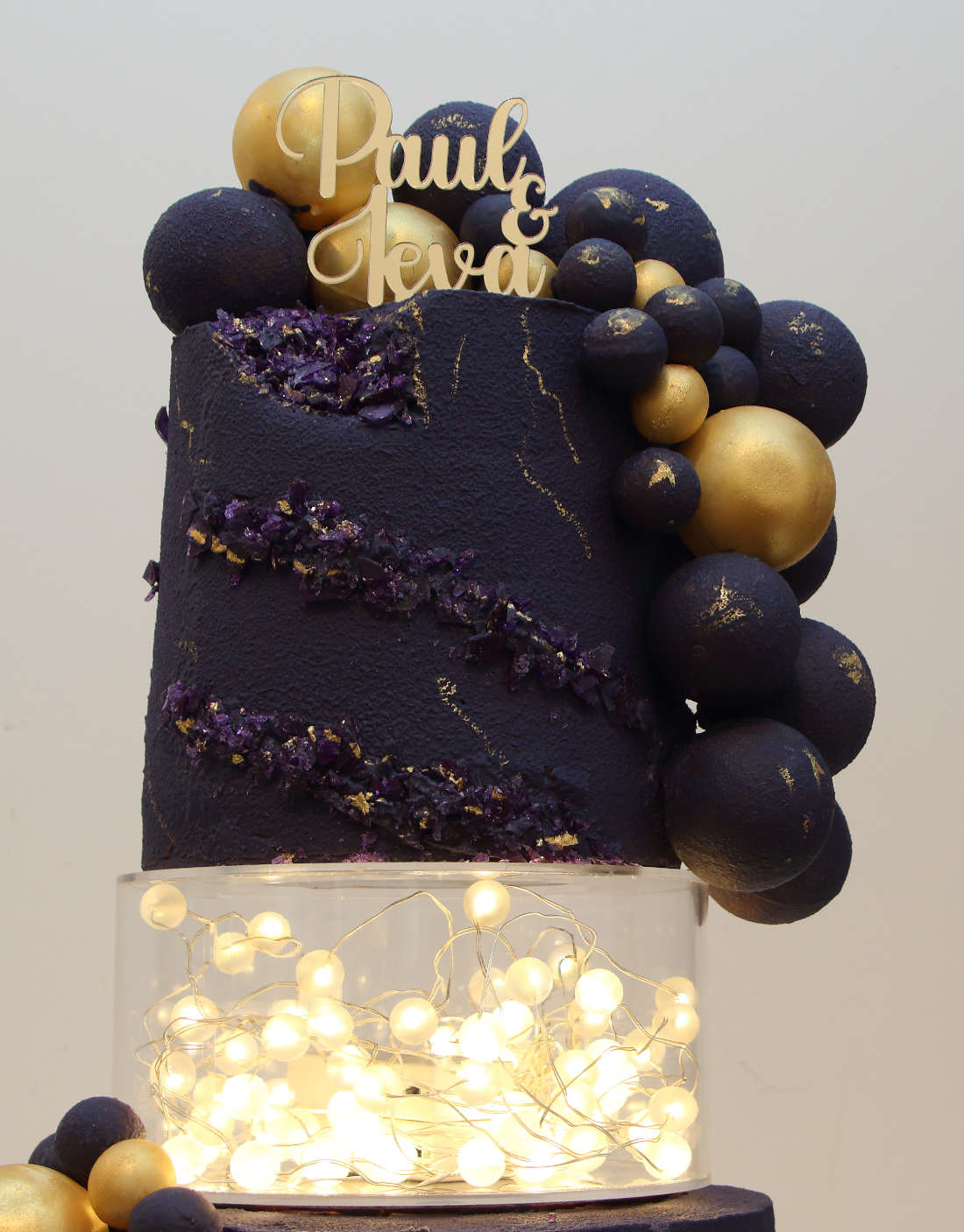 Wedding cake top tiers with balls and garlands