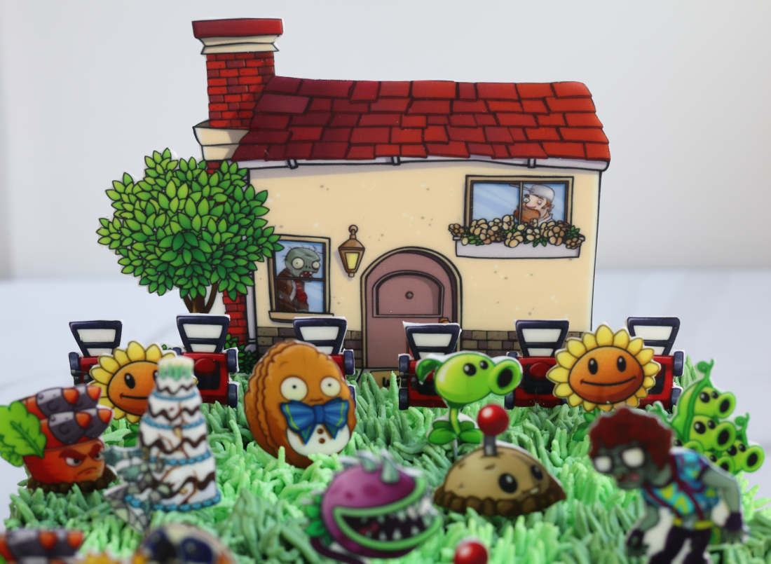 Cake with zombies, plants, and lawn mowers